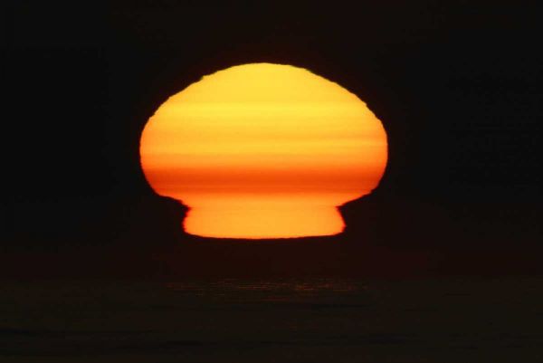 CA, La Jolla Sun at sunset distorts shape